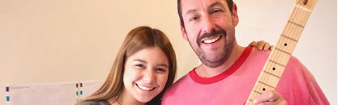 Andrea Ferrero stands with Adam Sandler