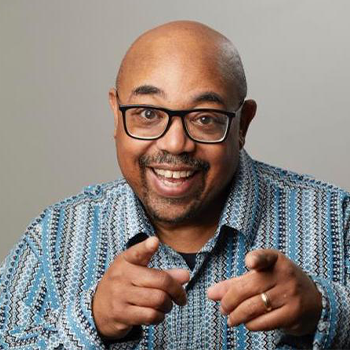 George Russell smiling and pointing at the camera.