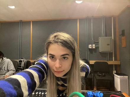 Riley Finkle working on a recording console in a studio