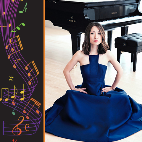 Soyeon Kate Lee in a long blue dress posing on the floor near a piano.