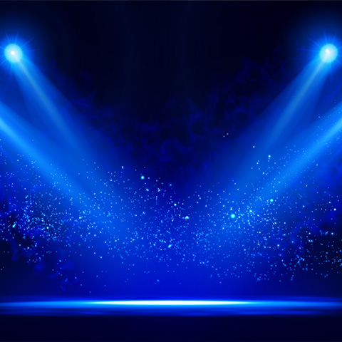 a stage with spotlights shining down 