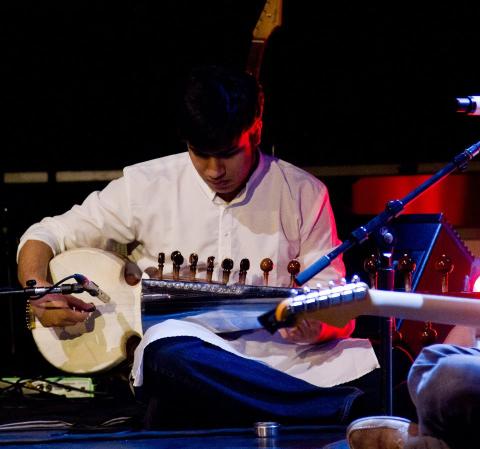 man playing a sarod