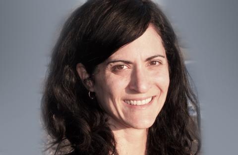 Alissa Cardone smiling with a gray background