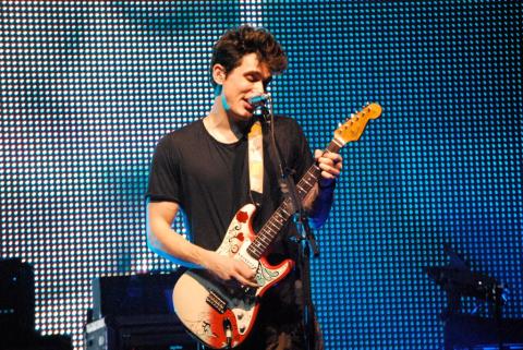 John Mayer playing a Fender Stratocaster on stage