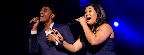 Two students singing on stage of the BPC