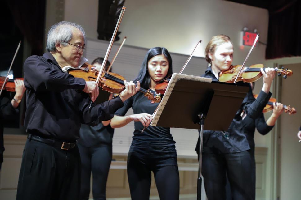 Lynn Chang, another student, and Svens Svens Skriveris performing onstage. 